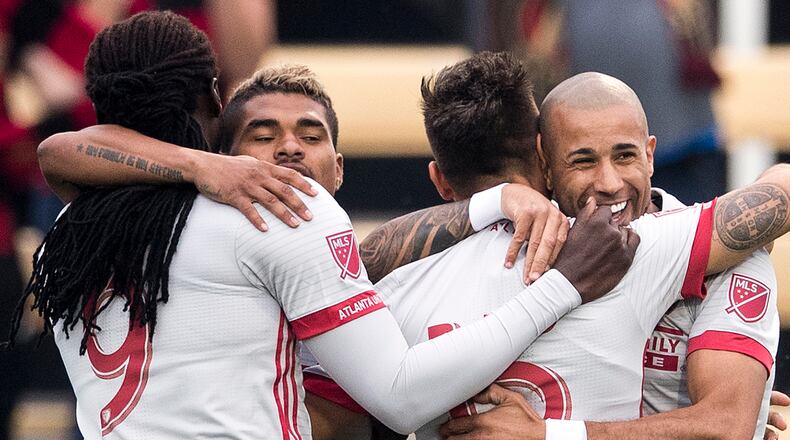 Atlanta United players celebrate their opening goal in a 2-1 loss to Columbus in the Carolina Challenge Cup onn Saturday. (Alex Holt)