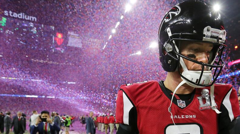 February 5, 2017, Houston: A dejected Matt Ryan walks off the field as the confetti flys falling to the Patriots 34-28 in the Super Bowl on Sunday Feb. 5, 2017, in Houston. Curtis Compton/ccompton@ajc.com