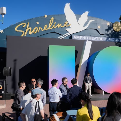 Attendees pose for photos before the keynote presentation at a Google I/O event in Mountain View, Calif., Tuesday, May 19, 2026. (AP Photo/Jeff Chiu)