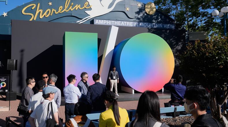 Attendees pose for photos before the keynote presentation at a Google I/O event in Mountain View, Calif., Tuesday, May 19, 2026. (AP Photo/Jeff Chiu)