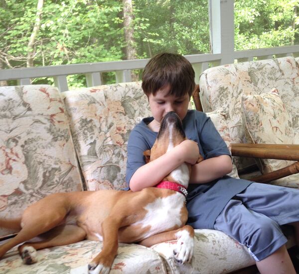 Best friends Jonny Hickey and his dog Xena share a snuggle on the couch.