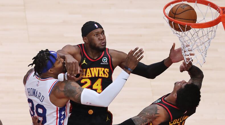 Philadelphia's Dwight Howard battles under the basket with Bruno Fernando (24) and John Collins on Monday, Jan. 11, 2021, at State Farm Arena. (Curtis Compton / curtis.compton@ajc.com)