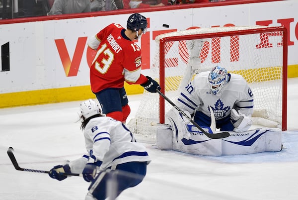 Florida Panthers center Sam Reinhart (13) shoots against Toronto Maple Leafs goaltender Joseph Woll (60) during the first period of Game 4 of a second-round NHL hockey playoff series, Sunday, May 11, 2025, in Sunrise, Fla. (AP Photo/Michael Laughlin)