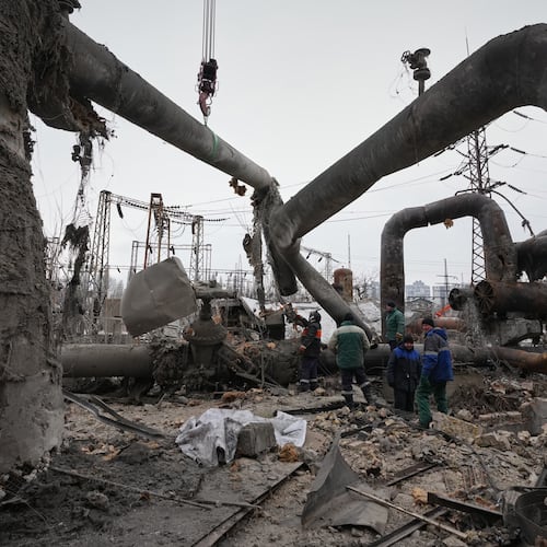 Workers clean up damage at Darnytsia Thermal Power Plant after a Russian attack in Kyiv, Ukraine, Wednesday, Feb. 4, 2026. (AP Photo/Sergei Grits)