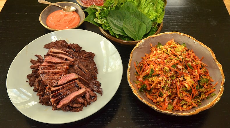 Soy-based marinated beef, Kimchi Slaw and sauces: Gochujang Sour Cream (orange sauce) and Ssamjang with romaine and perilla leaves await assembly. (Photo by Chris Hunt/Special)