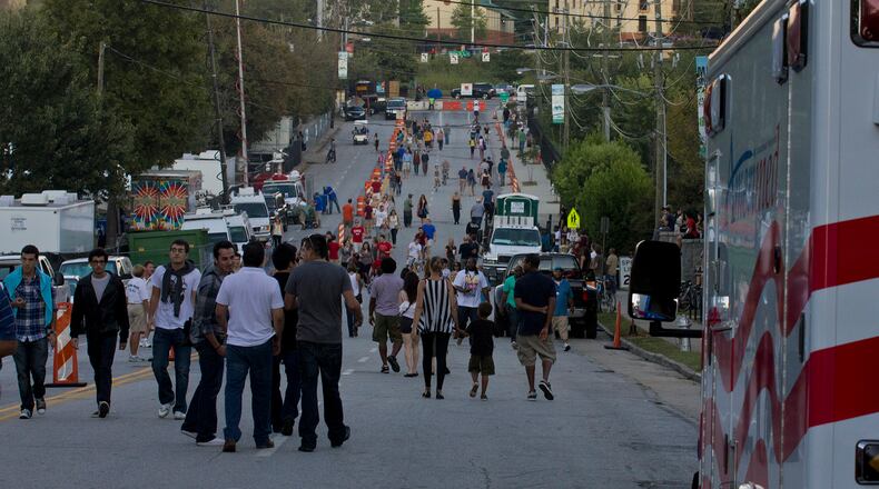 Crowds wander along 10th Street during Music Midtown in 2011. AJC Special