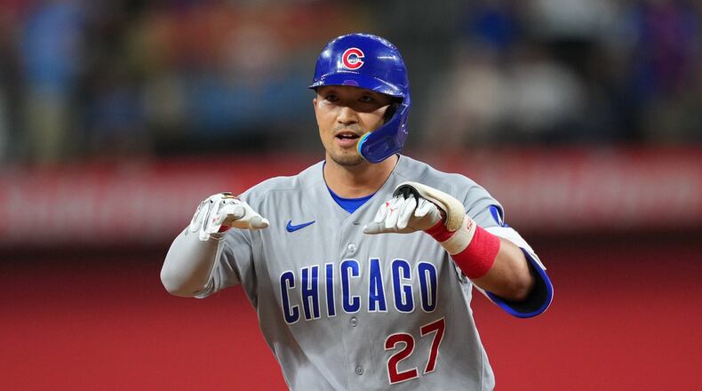 Chicago Cubs' Seiya Suzuki gestures while running the bases after hitting a two-run home run off Texas Rangers starting pitcher Kumar Rocker during the fourth inning of a baseball game Friday, May 8, 2026, in Arlington, Texas. (AP Photo/Julio Cortez)
