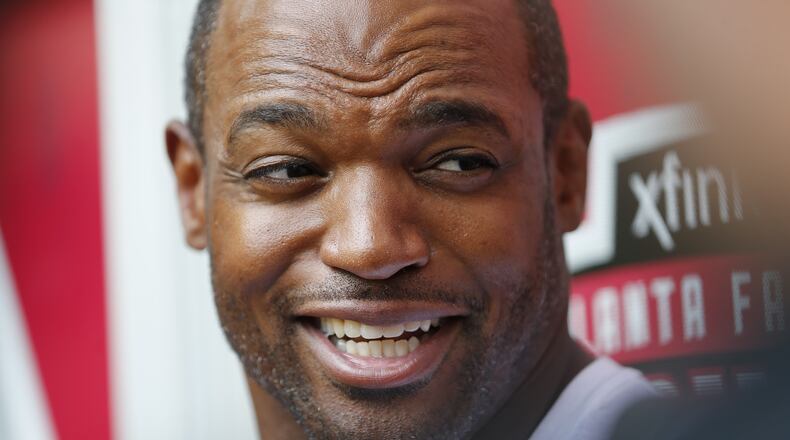 Newly acquired Atlanta Falcons defensive lineman Dwight Freeney talks with reporters as he reports for NFL football training camp Thursday, Aug. 4, 2016, in Flowery Branch, Ga. (AP Photo/John Bazemore)