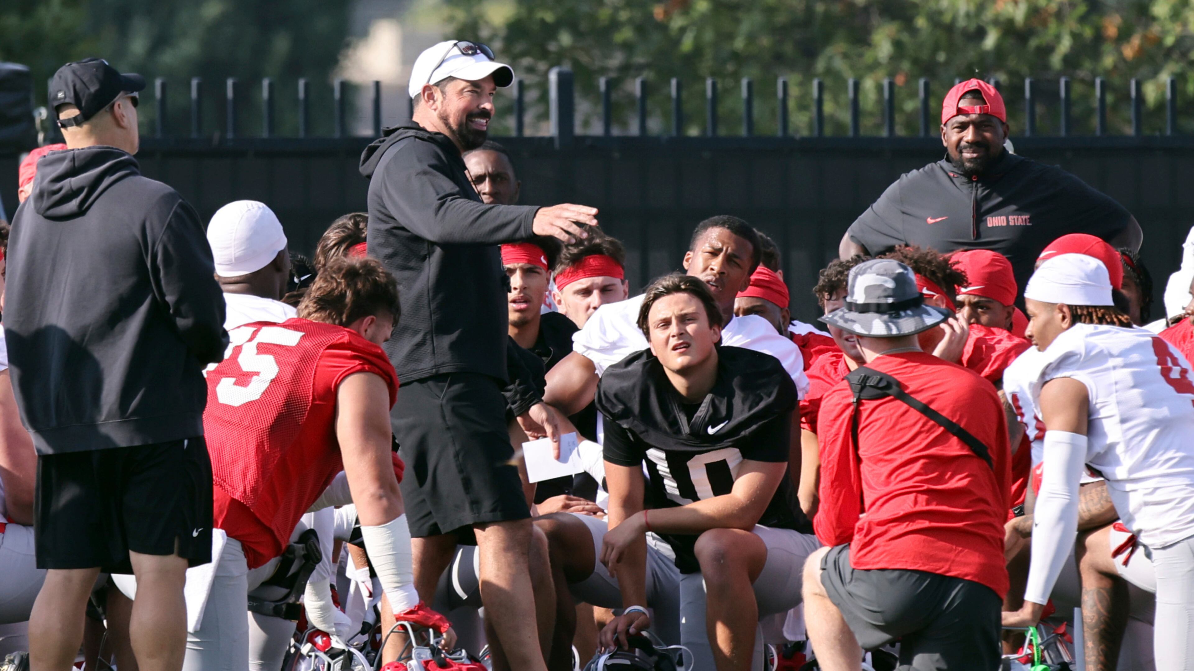 Ohio State coach Ryan Day talks to his team during NCAA college football practice in Columbus, Ohio, Friday, Aug. 1, 2025. (AP Photo/Paul Vernon)