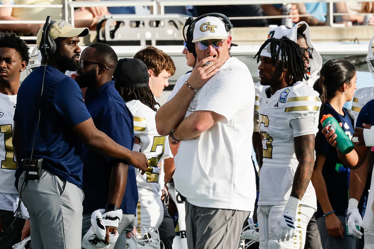 Georgia Tech head coach Brent Key, center, watches his team play BYU during the first half of the Pop-Tarts Bowl NCAA college football game Saturday, Dec. 27, 2025, in Orlando, Fla. (AP Photo/Kevin Kolczynski)