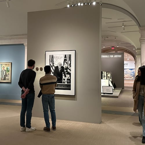 A photograph of President Donald Trump and a short plaque next to it are on display at the Smithsonian's National Portrait Gallery's "American Presidents" exhibit on Sunday, Jan. 11, 2026 in Washington. (AP Photo/Anna Johnson)
