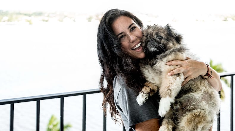 Kimberly Bellinger holds her 12-year-old dog Bonzo at her mother's 11th floor condo at Rapallo North condominiums in West Palm Beach on Thursday, October 1, 2015. Bonzo fell from the 11th floor balcony in late April 2015, and only broke a rib, Bellinger said. "It's a miracle," she said. (Thomas Cordy / The Palm Beach Post)