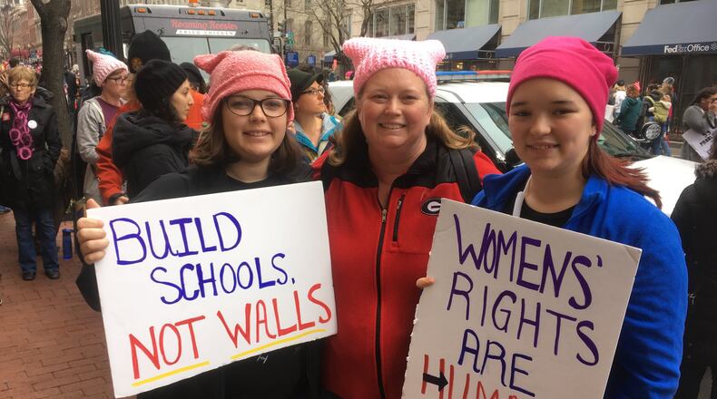Jaymie Goitia of Monroe, center, and her daughters Lana, 20, left, and Emily, 14, took a bus from Athens to attend the march. Photo: Jennifer Brett, jbrett@ajc.com