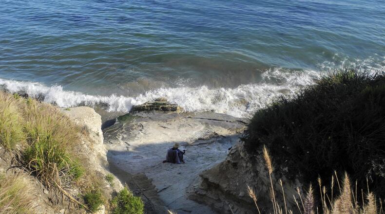 A beachgoer enjoys the water by Aniso Trail between California's Refugio State Beach and El Capitan State Beach on May 20, 2017. (Denise Florez/Los Angeles Times/TNS)