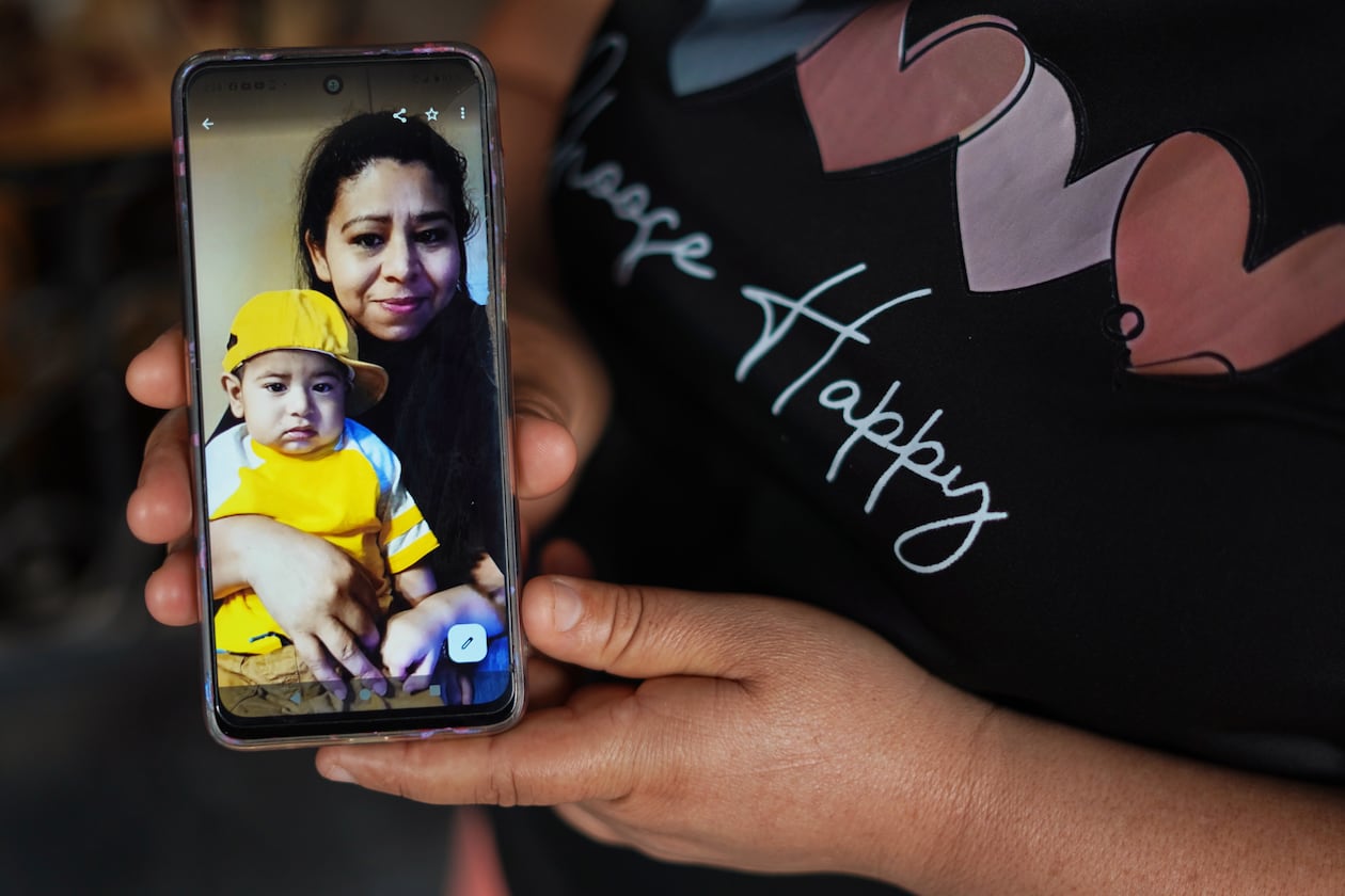 Carmen Gavidia Ramírez shows a portrait of her sister, Maribel Ramírez, and her nephew Evan, who died in a crash in Jackson County. Ramírez is shown at her home in Tepetitan, El Salvador. (AP Photo/Salvador Melendez)