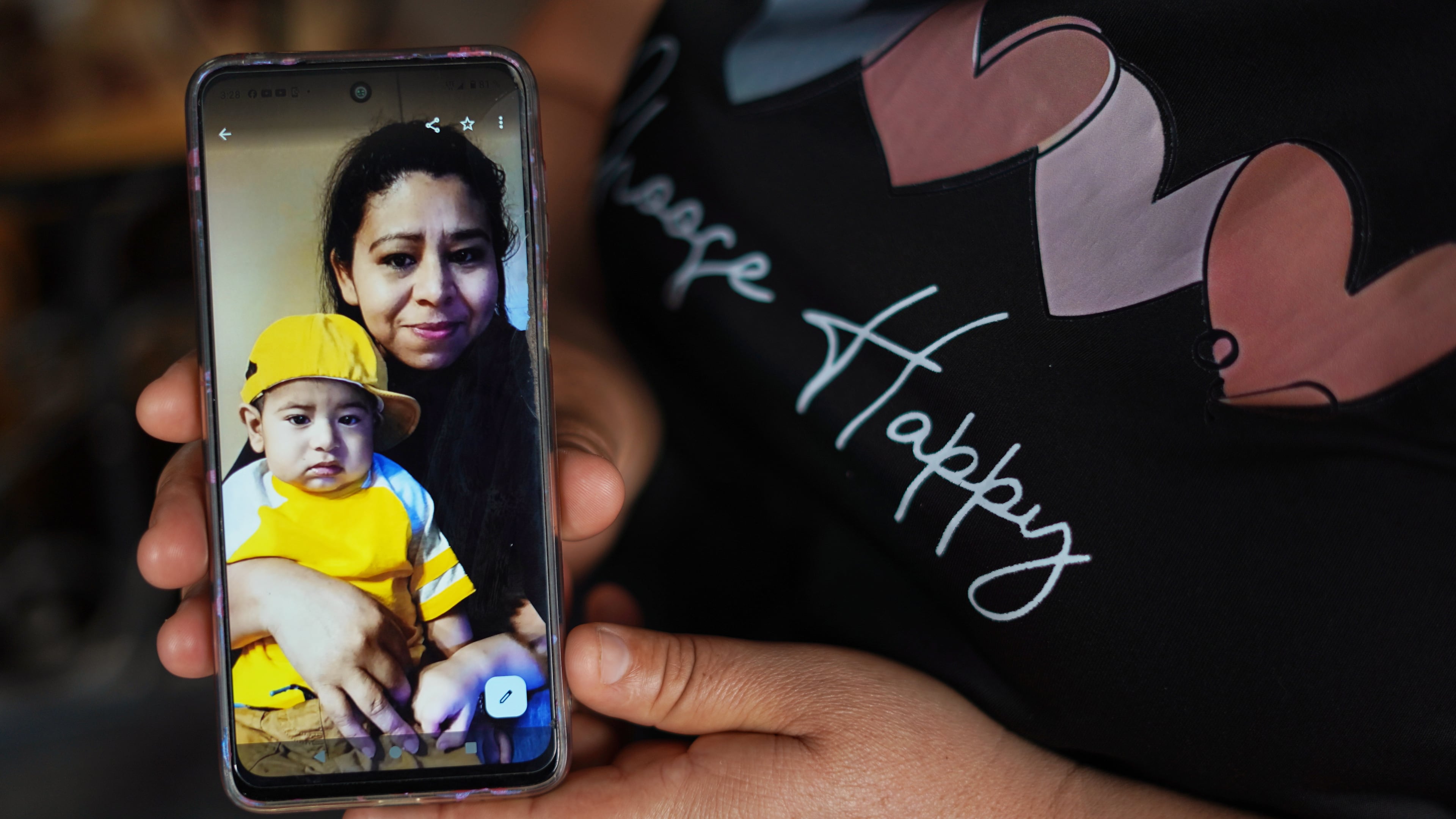 Carmen Gavidia Ramírez shows a portrait of her sister, Maribel Ramírez, and her nephew Evan, who died in a crash in Jackson County. Ramírez is shown at her home in Tepetitan, El Salvador. (AP Photo/Salvador Melendez)