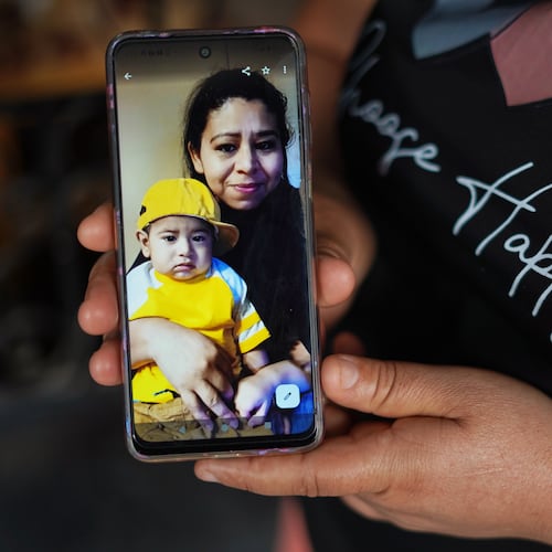 Carmen Gavidia Ramírez shows a portrait of her sister, Maribel Ramírez, and her nephew Evan, who died in a crash in Jackson County. Ramírez is shown at her home in Tepetitan, El Salvador. (AP Photo/Salvador Melendez)