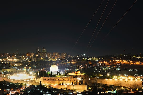 Traces are seen over Jerusalem during a missile attack alert, Friday, June 13, 2025. (AP Photo/Ohad Zwigenberg)