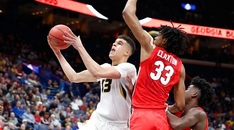 Michael Porter Jr. drives against Nicolas Claxton.
