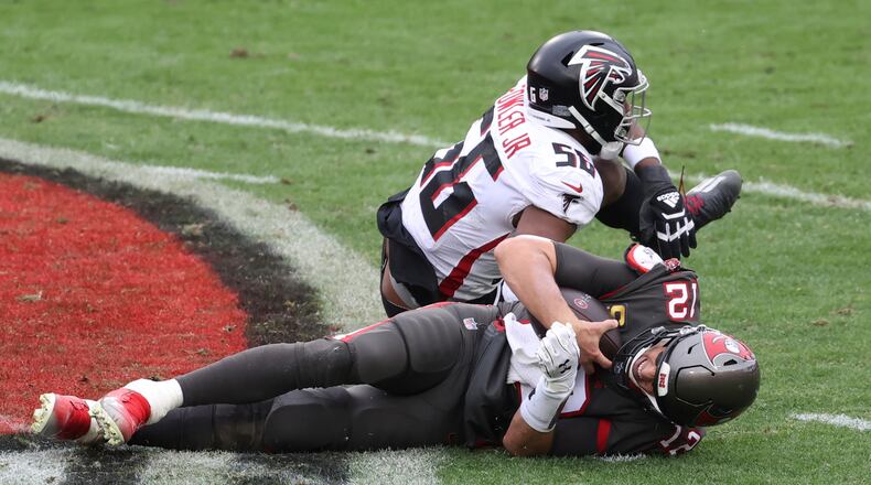 Falcons defensive end Dante Fowler (56) sacks Tampa Bay Buccaneers quarterback Tom Brady (12) during the second half Sunday, Jan. 3, 2021, in Tampa, Fla. (Mark LoMoglio/AP)