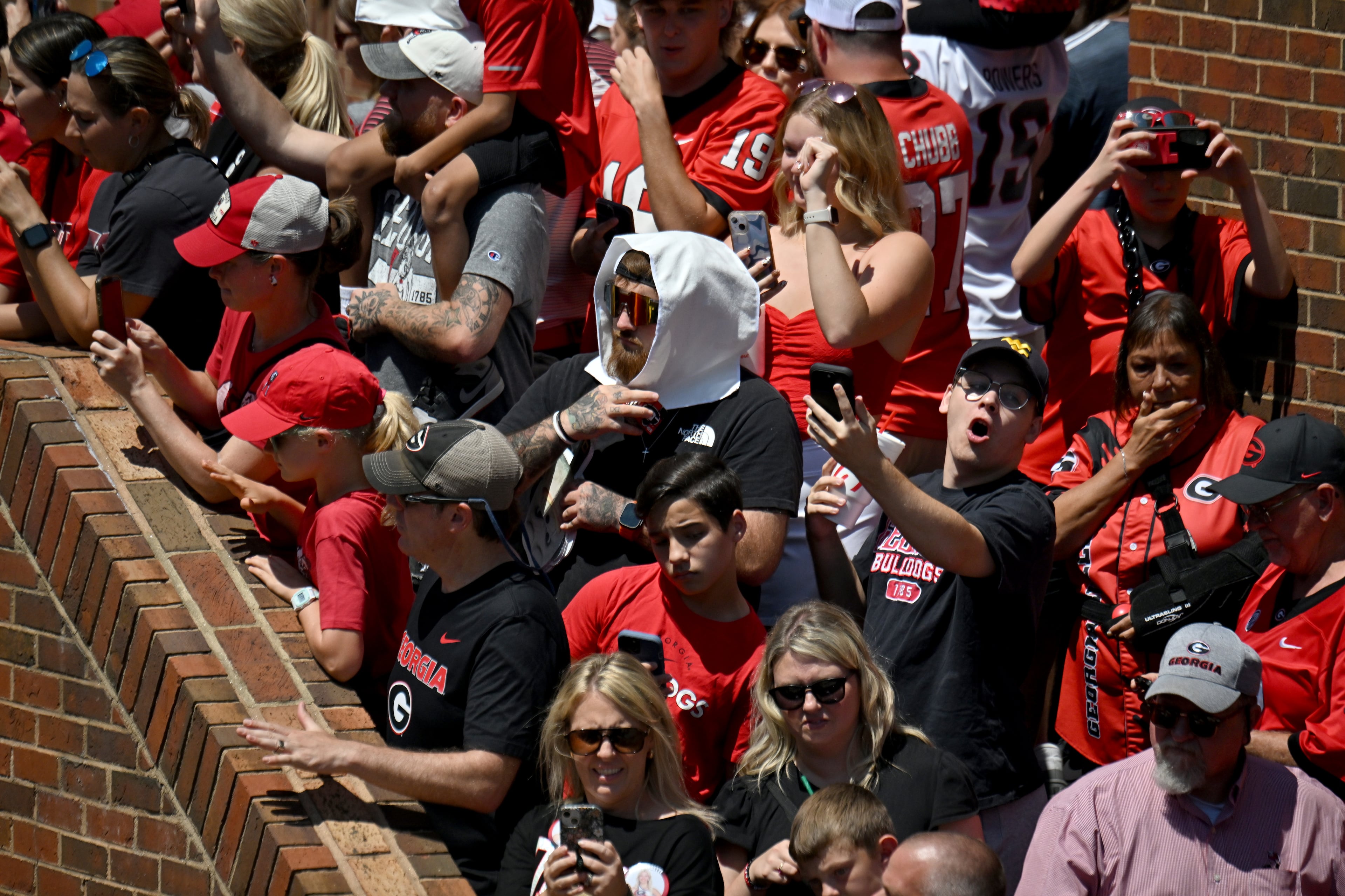 Georgia fans cheer as players and staff arrive during Dawgs Walk before Georgia football's season opener and home opener against Marshall at Sanford Stadium, Saturday, August 30, 2025, in Athens. (Hyosub Shin / AJC)