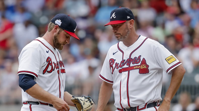 Braves pitcher Bryce Elder (left) — pictured during a mound visit by pitching coach Jeremy Hefner on June 7 against the Pirates — allowed eight runs and 12 hits with two walks in six innings Sunday against the Brewers. (Erik S. Lesser/AP)