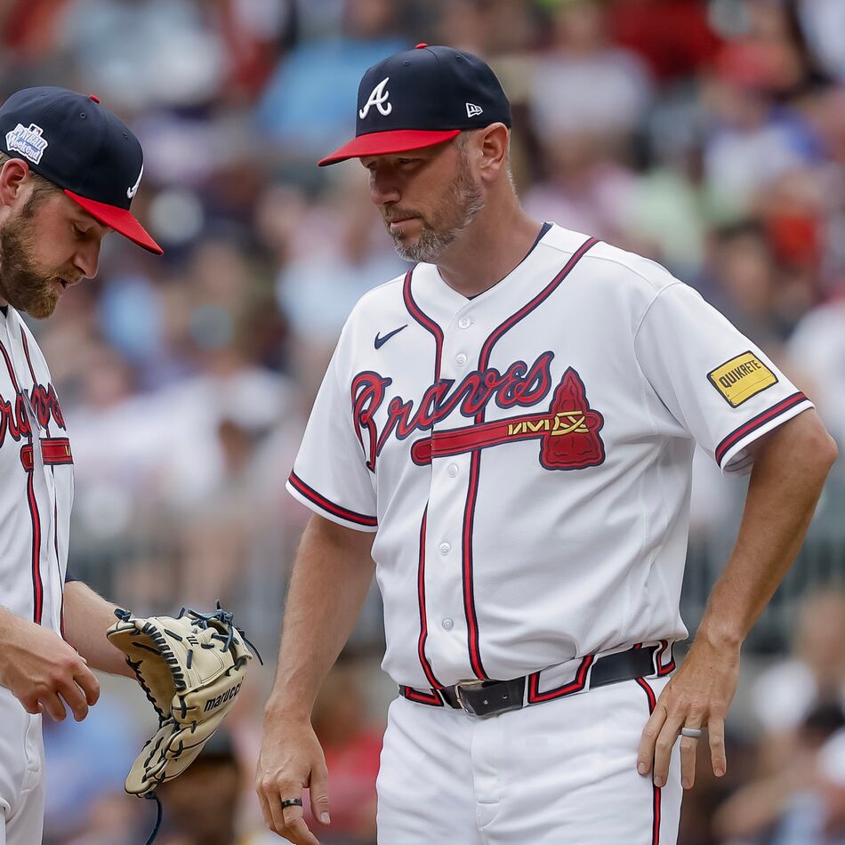 Braves pitcher Bryce Elder (left) — pictured during a mound visit by pitching coach Jeremy Hefner on June 7 against the Pirates — allowed eight runs and 12 hits with two walks in six innings Sunday against the Brewers. (Erik S. Lesser/AP)