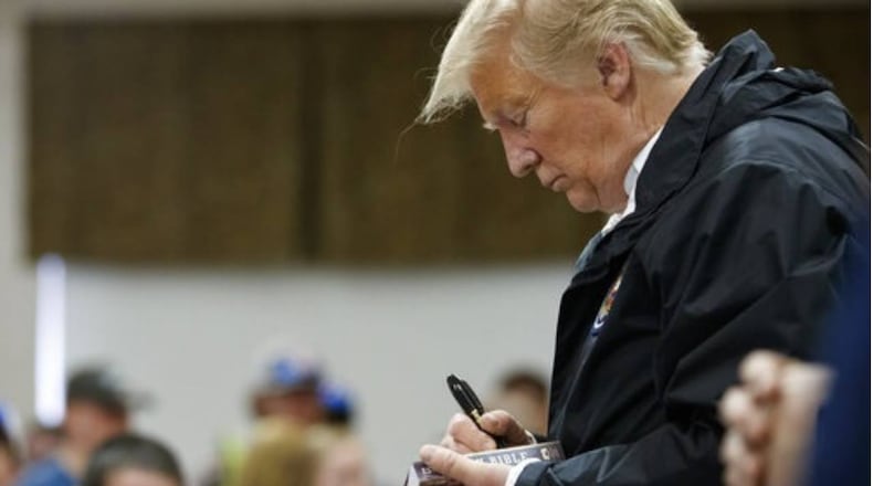 President Donald Trump signs a Bible in Alabama in 2019. (Carolyn Kaster/AP)
