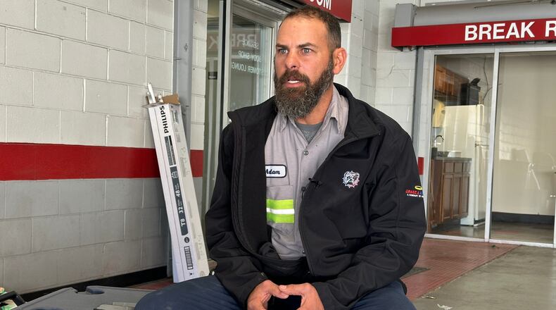 Adam Bowman, a supervisor at Grade A Auto Parts Recycling, is interviewed on Thursday, Nov. 13, 2025 in Louisville, Kentucky, about his actions after the UPS plane crash. (AP Photo/Dylan Lovan)