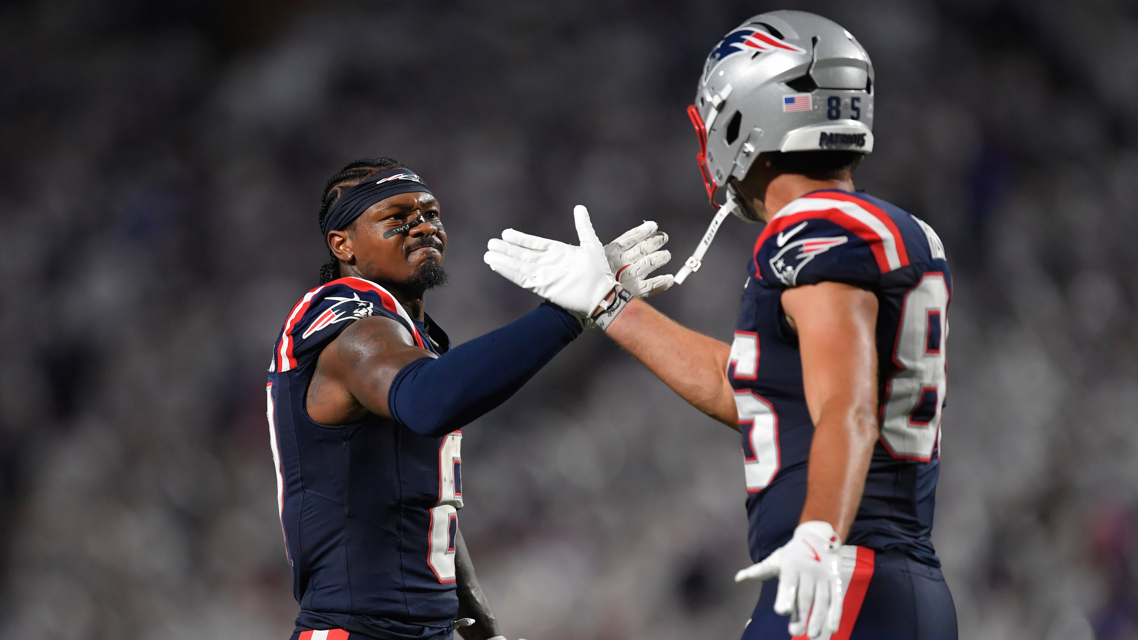 New England Patriots wide receiver Stefon Diggs, left, and New England Patriots tight end Hunter Henry, right, celebrate a play against the Buffalo Bills during the second half of an NFL football game, Sunday, Sept. 5, 2025, in Orchard Park, N.Y. (AP Photo/Adrian Kraus)