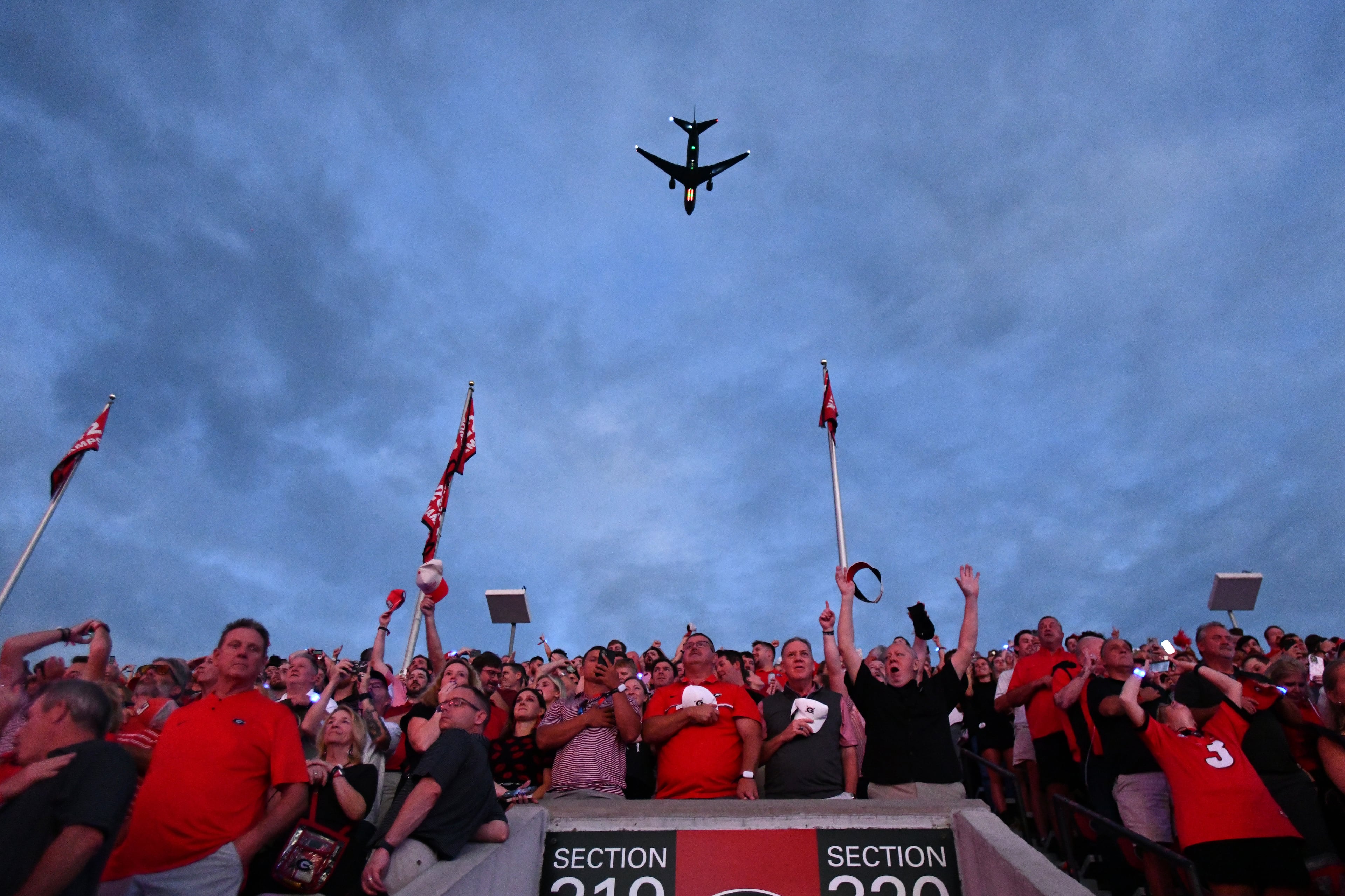 Football fans watch a flyover before Georgia game against Alabama at Sanford Stadium, Saturday, September 27, 2025, in Athens. (Hyosub Shin / AJC)