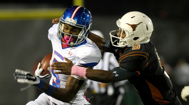 Marietta, Ga. -- Kell junior defensive back Michael McCain (9) makes a tackle on Riverwood running back Marvin Kinsey (5) late in the second half of play at Kell High Friday, October 16, 2015. Special/Daniel Varnado