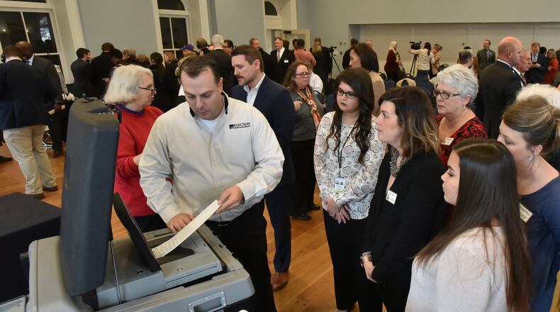 Tobey Dingbaum with Election Systems & Software demonstrates his company’s ballot-marking device voting system at The Depot on Thursday. Election companies demonstrated voting systems to the public and to officials, showing how Georgia could switch to paper ballots. HYOSUB SHIN / HSHIN@AJC.COM