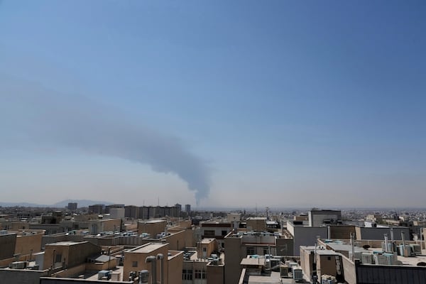 Huge smoke rises up from an oil facility after a Saturday explosion in southern Tehran, Iran, Sunday, June 15, 2025. (AP Photo/Vahid Salemi)