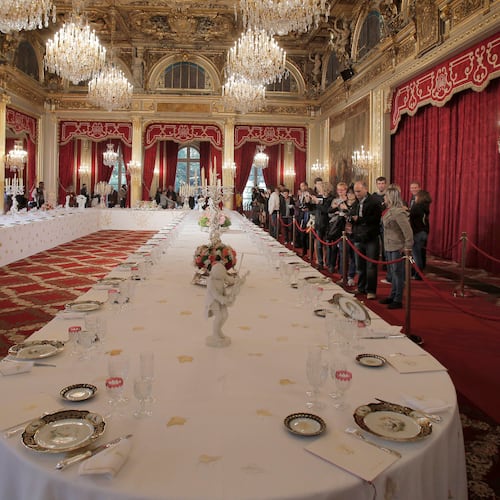 FILE - Visitors view a table dressed with plates and glasses for official dinners at the Elysee Palace in Paris, Saturday, Sept. 15, 2012. France's national buildings and administrations were opened to the public for Heritage Days weekend. (AP Photo/Christophe Ena, File)