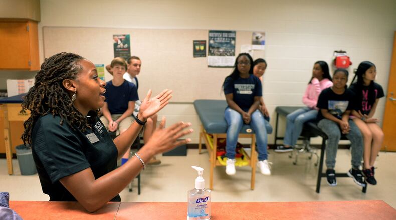 SEPTEMBER 5, 2014 JOHNS CREEK Cherell Lawson teaches sports medicine techniques during a class at Northview High School in Johns Creek, Friday, September 5, 2014. Lawson is an athletic trainer with Emory Healthcare at Johns Creek and was hired this year part-time to teach health sciences at Northview High School despite her lack of a teaching credential. Fulton County Schools would not have been able to employ her without a personnel waiver that came with their charter district status. Georgia school districts must decide soon whether they will push more authority down to the school level or face potential financial sanctions. The state mandate to consider choosing either a charter form of management the status quo or something in between called “IE2” is driven by the notion that more local control will improve outcomes. Districts that choose the status quo will lose all sorts of waivers, many, such as exemptions from class size limits and minimum number of school days, can save money in tight times. But details matter: how much local control do either charter or IE2 allow, and does it matter? We can look to several metro Atlanta districts — Gwinnett, Fulton, Decatur and Marietta — that have already reorganized under one of these new formats to see whether it’s made any difference. Atlanta, DeKalb and Cobb will be voting in coming months on staff recommendations — for charter district in Atlanta and DeKalb and for IE2 in Cobb. KENT D. JOHNSON / KDJOHNSON@AJC.COM