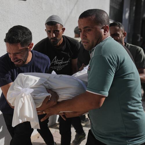 Relatives carry the body of Shadi Abu Sweilem, who was killed in an Israeli airstrike, during his funeral at Al-Shifa Hospital in Gaza City Sunday, June 14, 2026. (AP Photo/Jehad Alshrafi)