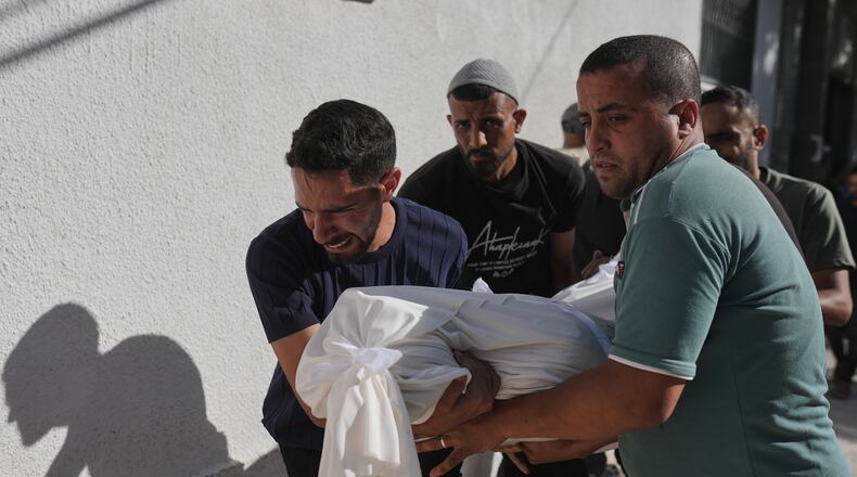 Relatives carry the body of Shadi Abu Sweilem, who was killed in an Israeli airstrike, during his funeral at Al-Shifa Hospital in Gaza City Sunday, June 14, 2026. (AP Photo/Jehad Alshrafi)