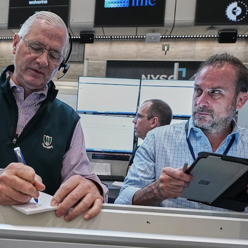 Options traders David Rush, left, and Scott Frinzi work on the floor of the New York Stock Exchange, Tuesday, June 16, 2026. (AP Photo/Richard Drew)