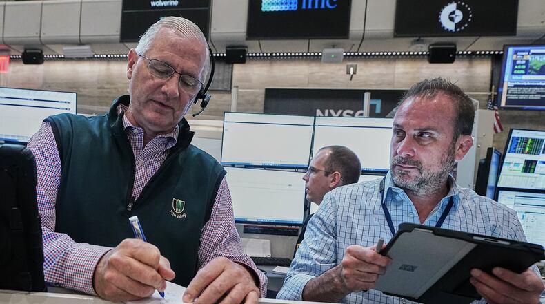 Options traders David Rush, left, and Scott Frinzi work on the floor of the New York Stock Exchange, Tuesday, June 16, 2026. (AP Photo/Richard Drew)