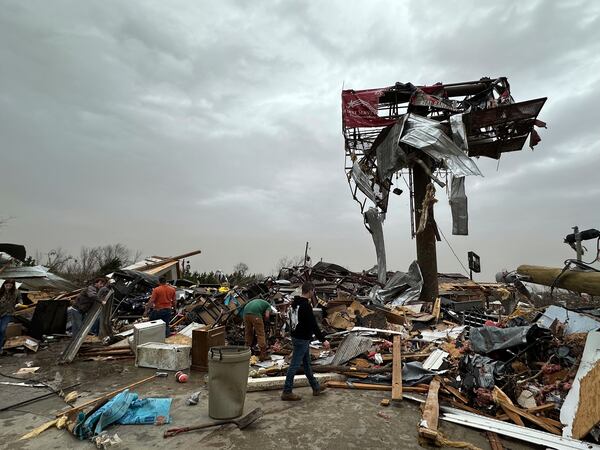 People work through the debris of the Cave City Auto Parts store on Saturday, March 15, 2025 after a severe weather storm Friday night in Cave City, Ark. (Staci Vandagriff/Arkansas Democrat-Gazette via AP)
