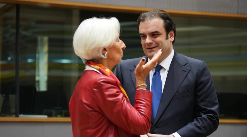 European Central Bank President Christine Lagarde, left, speaks with Greece's Finance Minister Kyriakos Pierrakakis during a meeting of eurozone finance ministers at the EU Council building in Brussels, Thursday, Dec. 11, 2025. (AP Photo/Virginia Mayo)
