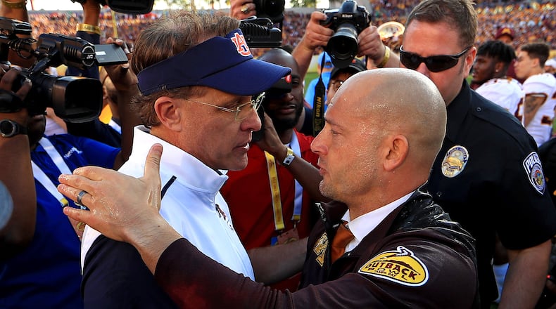 Auburn coach Gus Malzahn (left) shakes hands with Minnesota's P.J. Fleck after the game. (Photo by Mike Ehrmann/Getty Images)