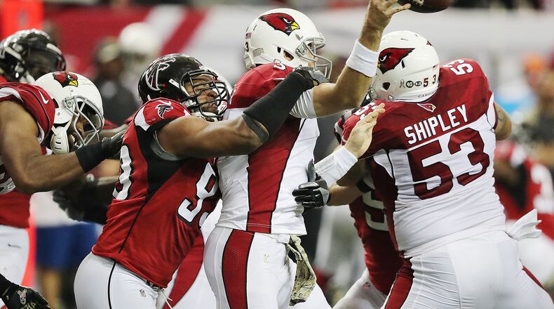 Falcons defensive end Dwight Freeney hits Arizona quarterback Carson Palmer to force an incomplete pass during the fourth quarter of a game on Nov. 27. It was the Falcons’ first game after the bye, which allowed Freeney a chance to rest a torn quad. (Curtis Compton/ccompton@ajc.com)