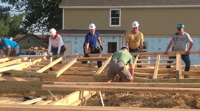 From 2016 (Memphis): Former President Jimmy Carter (left, white shirt) and Garth Brooks (gold shirt) help raise a wall on the first day of a weeklong Habitat for Humanity build in Memphis. (JILL VEJNOSKA / Jill.Vejnoska@ajc.com)