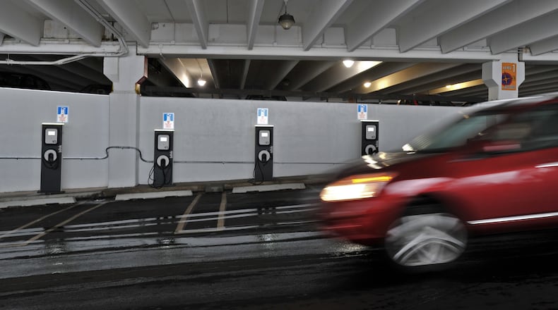 Electricvehicle charging stations line the lower level of the Bloomingdales' parking at Lenox Square Mall. Hundreds of chargers for electric cars are being installed in car-centric metro Atlanta, all part of a broader push to find ways to ease pollution and reduce gasoline demand.
