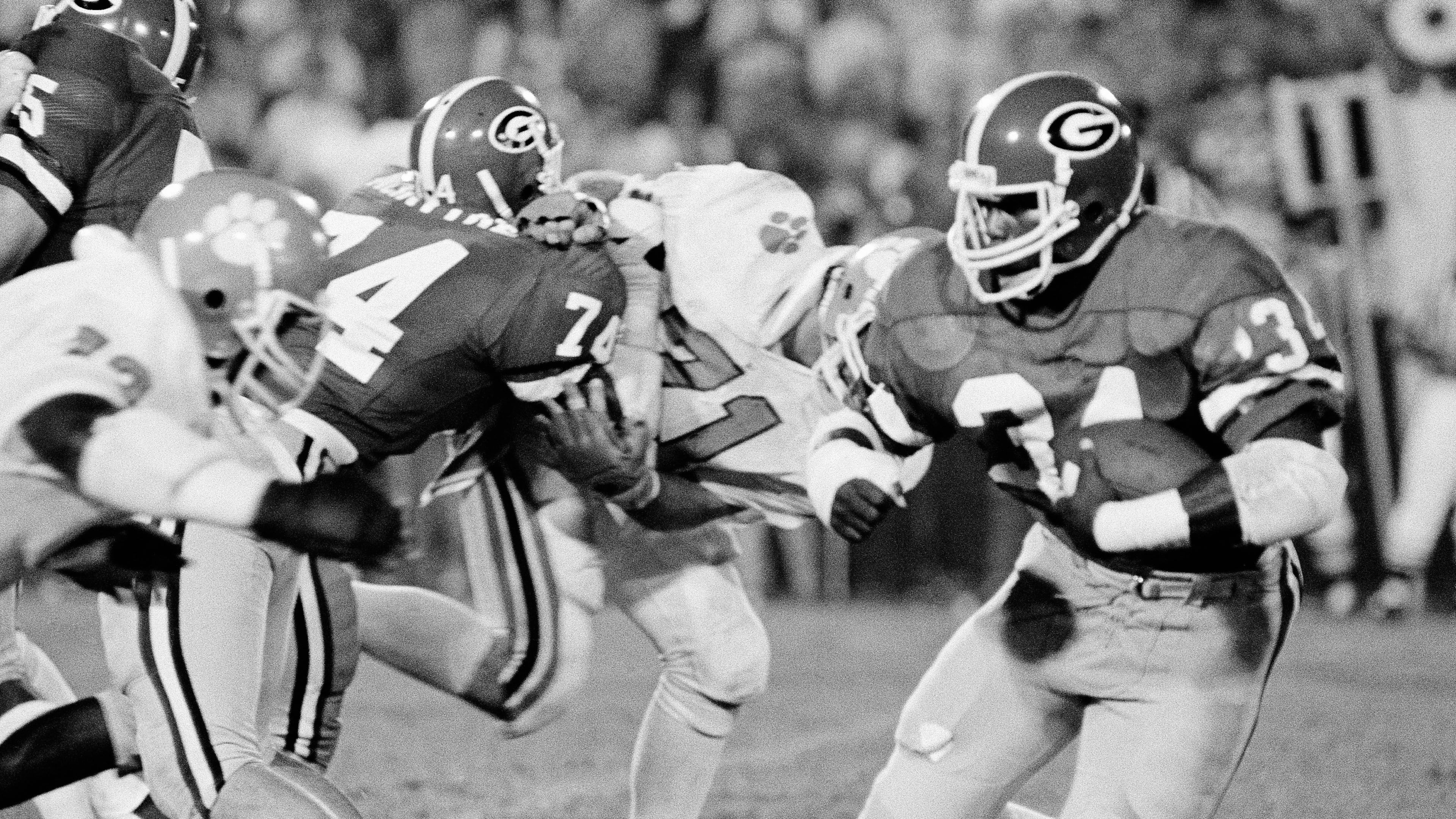 Georgia's Herschel Walker (right) joins Oklahoma State's Barry Sanders as the running backs for the first-team offense on the Associated Press all-time All-American team. (Charles Kelly/AP 1982)