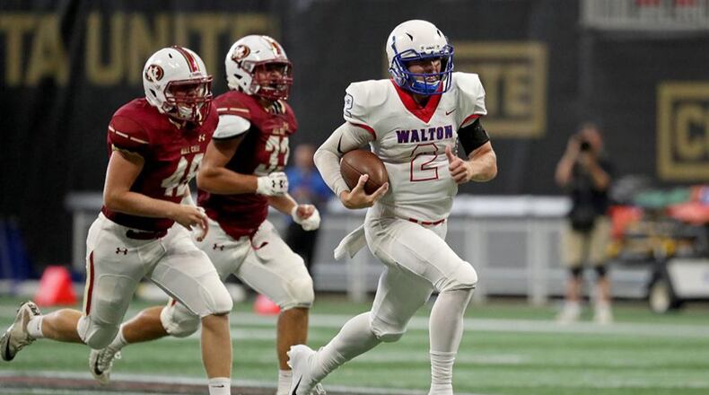 Walton quarterback Austin Kirksey (2) runs for a first down in the second half against Mill Creek during the Corky Kell Classic game Saturday, Aug. 18, 2018, at Mercedes-Benz Stadium in Atlanta.