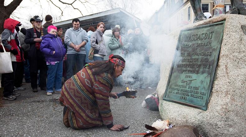 Juan Gonzalez of Boston rekindles a small fire with the smoke symbolizing a ritual for healing and a connection with the "creator."  He has been attending this  day of mourning for 30 years.  "We feel the pain of the Wampanoag," said Gonzalez.  United American Indians of New England gather for the National Day of Mourning across from Plymouth Rock in Plymouth, MA on Thursday, November 25, 2010.  The day signifies the deaths of American Indians at the hands of early settlers and colonists and the independence of American Indians. (Photo by Yoon S. Byun/The Boston Globe via Getty Images)