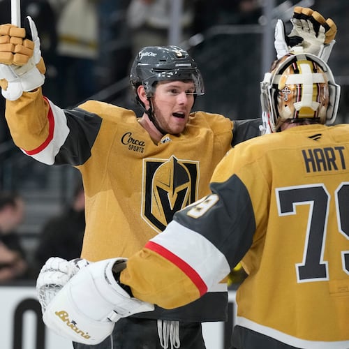 Vegas Golden Knights defenseman Jeremy Lauzon, left, celebrates with Vegas Golden Knights goaltender Carter Hart (79) after defeating the Utah Mammoth in Game 1 of a first-round NHL hockey Stanley Cup playoff series Sunday, April 19, 2026, in Las Vegas. (AP Photo/John Locher)